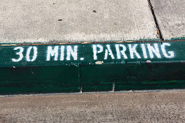 istock Green painted curb sidewalk indicating 30 Min Parking limit 2254190906