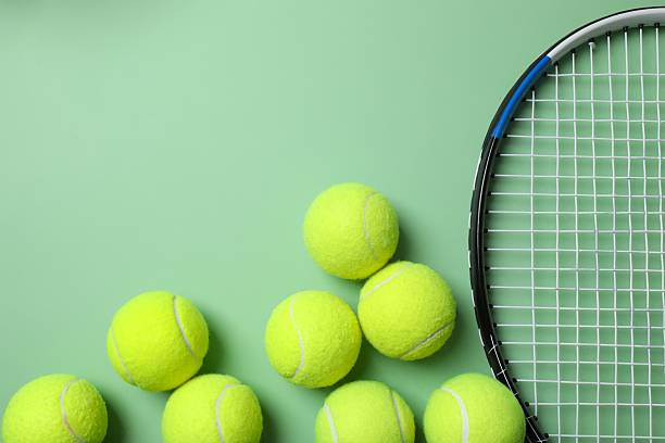 istock Tennis racket and balls on green background 2254191650