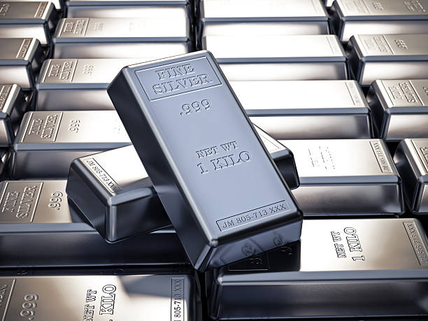Multiple one-kilo silver bars are neatly arranged, showcasing their shine and texture, reflecting wealth, stability, and precious metal investment. The stamped inscriptions indicate purity and weight, highlighting the bars as a form of tangible asset.