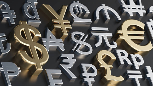 Various currency symbols are arranged in a creative layout on a dark surface. The symbols represent money from different countries, highlighting their importance in global finance.
