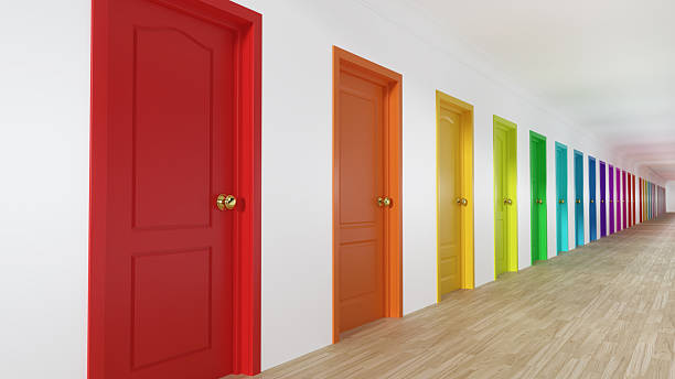 istock Multi-colored doors line a long hallway in an indoor space during bright daylight hours 2254195739