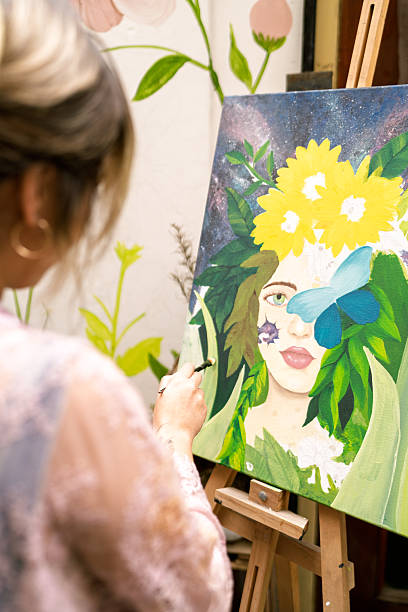 istock Visual artist painting nature-inspired portrait on canvas 2254197098