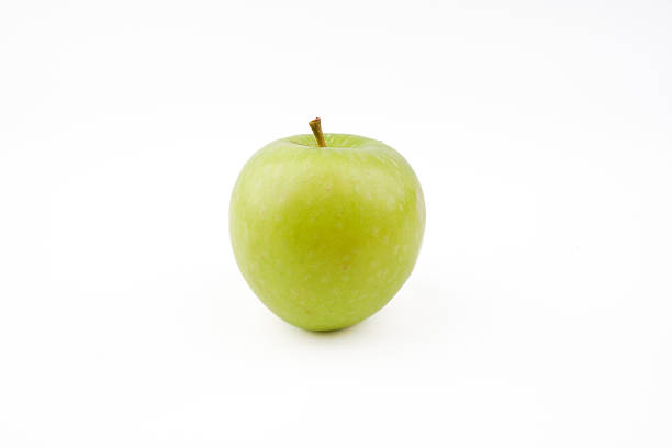 Green apple isolated on white background representing fresh fruit, healthy eating, natural produce, and simple food ingredient in clean minimal presentation.