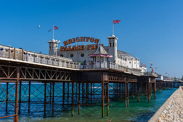 Brighton and Hove, UK - 20th June 2025The Brighton Palace Pier with its classic white Victorian pavilions on a sunny summer day. People are walking along the deck.