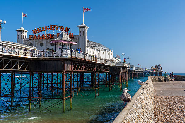 Brighton and Hove, UK - 20th June 2025The Brighton Palace Pier with its classic white Victorian pavilions on a sunny summer day. People are walking along the deck.