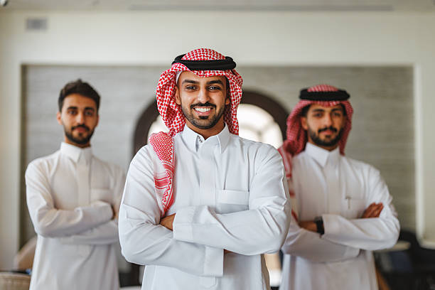 istock Middle Eastern Entrepreneurs in Traditional Attire Smiling in Modern Office 2254202553