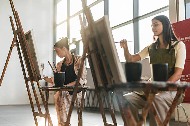 istock Young Middle Eastern Women Painting in a Sunlit Art Studio 2254203362