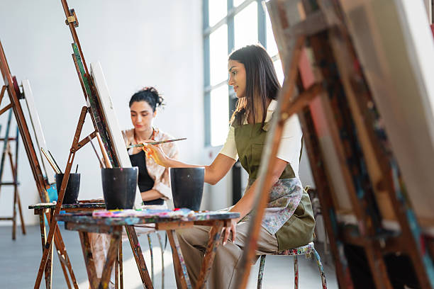 istock Young Middle Eastern Artists Working On Canvases In Sunlit Studio Space 2254204987