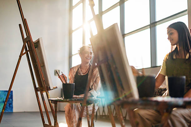 istock Young Middle Eastern Women Painting in a Sunlit Art Studio 2254205019