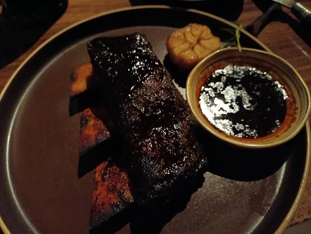 istock Beef steak and pork ribs with various sauce and condiments 2254211020