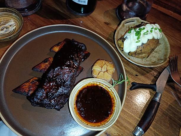 istock Beef steak and pork ribs with various sauce and condiments 2254211055