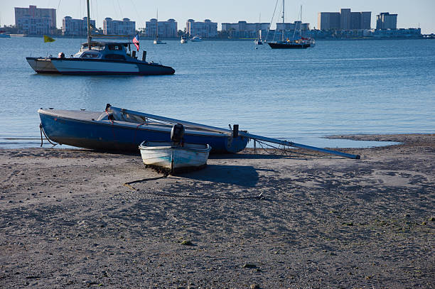 Old wooden fishing boat on the sand seashore beach.