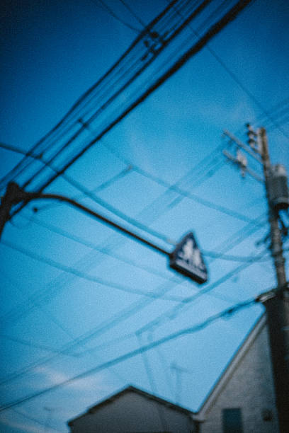 istock Blurred Pedestrian Sign and Power Lines Creating an Abstract Urban Sky 2254216630