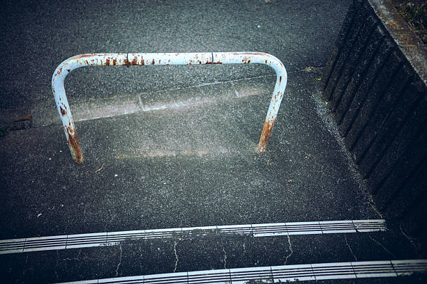 Rusty Guardrail on a Colorful Pedestrian Path, Urban Boundary Concept