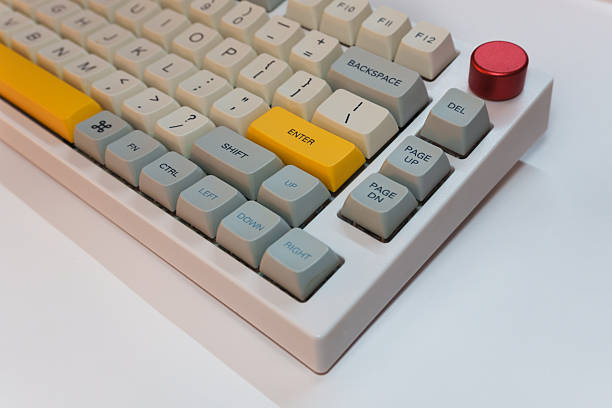 istock White mechanical keyboard with bright Enter key on white background, minimalism, keyboard buttons. A keyboard with a yellow key 2254223766