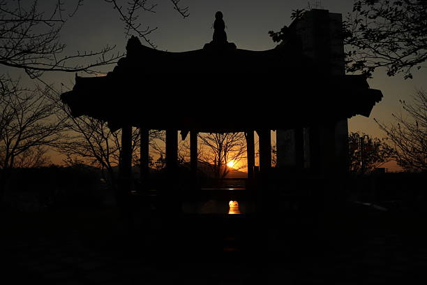 istock Serene Sunset Through Traditional Asian Pavilion Silhouette 2254223770