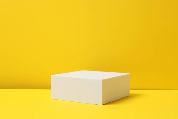 istock White podium on a yellow background 2254225292