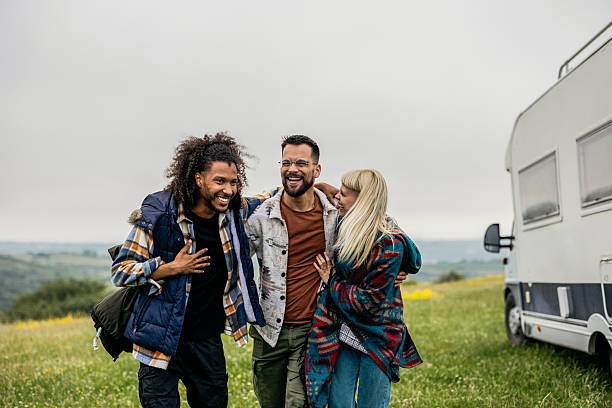 istock Group of friends embracing while laughing on camping trip 2254225390
