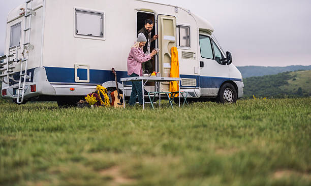 istock Couple enjoying coffee while camping with camper van 2254225396