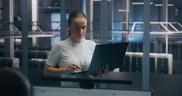 istock Experienced Female Engineer Uses Portable PC Run Diagnostics Performance Metrics 2254228572