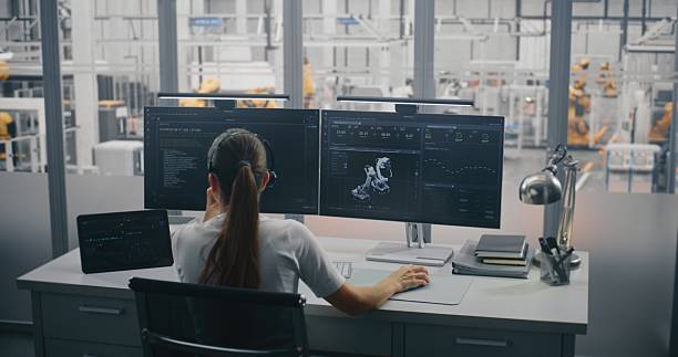 istock Female Engineer on Headset, Managing 3D Robot Automation Model and Performance Metrics on Monitors 2254228751