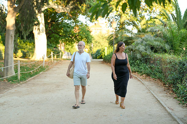 istock A man and a woman are walking down a path in a park 2254229699