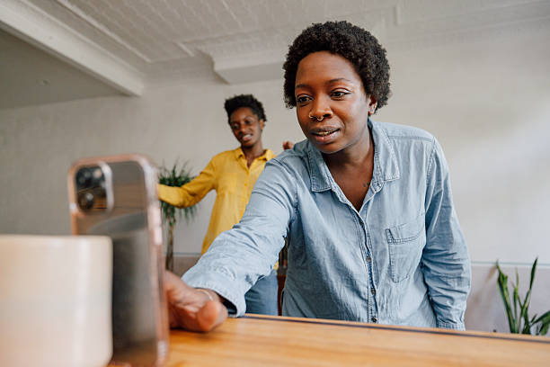 istock Friendly wave toward smartphone camera at home 2254235889