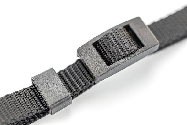 A close-up shot showcases a black nylon strap, featuring a plastic buckle. The rough texture of the woven nylon contrasts with the smooth, matte finish of the buckle on a white background.