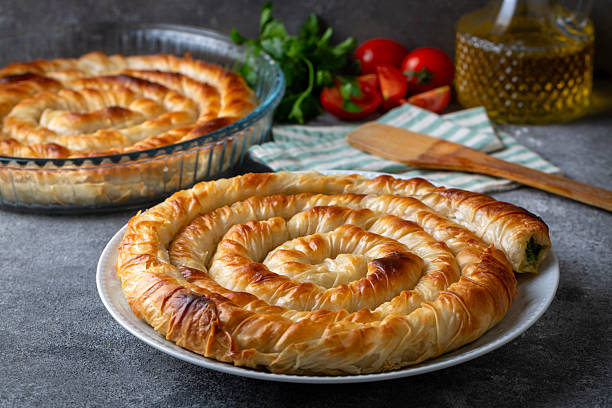 istock Turkish Tepsi Boregi, Round Borek, Tray pastry (Turkish name; rulo borek - ispanakli borek) 2254241157