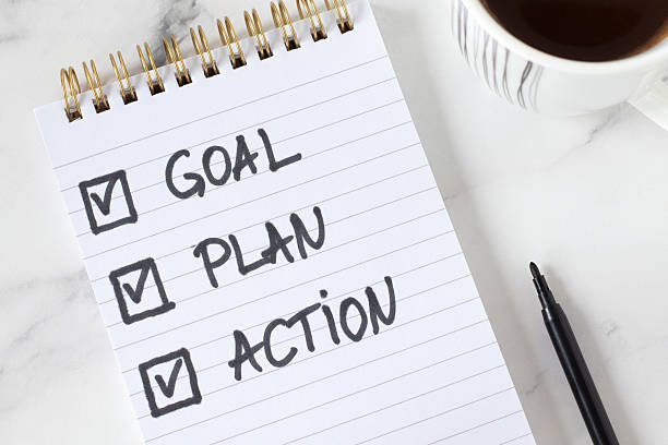 istock Goal, plan, action, inspirational handwritten checklist text in notebook with coffee cup on white marble background 2254242365