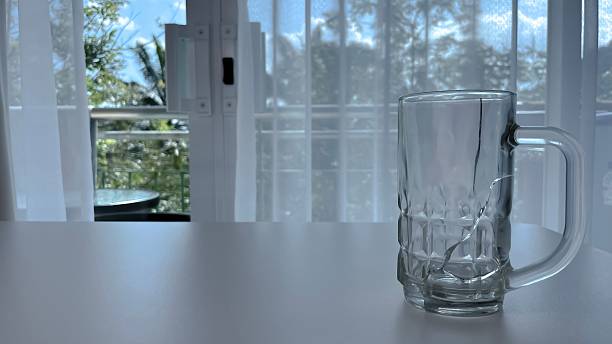 Extreme close-up of water about to overflow from a drinking glass.\nSurface Tension
