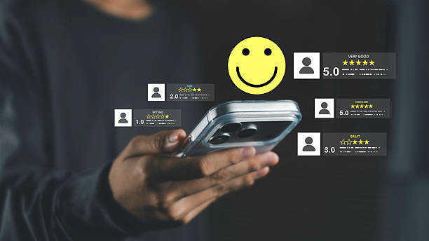 istock A user checking product reviews and star ratings on a mobile device with a smiley face symbolizing customer satisfaction and positive feedback. 2254243700