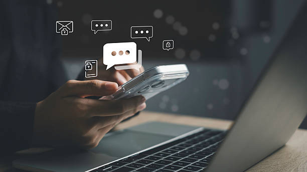 istock Secure live chat and messaging communication. Person holding smartphone with chat bubble icons, representing instant messaging, online conversation, data privacy, and encrypted digital communication. 2254243721