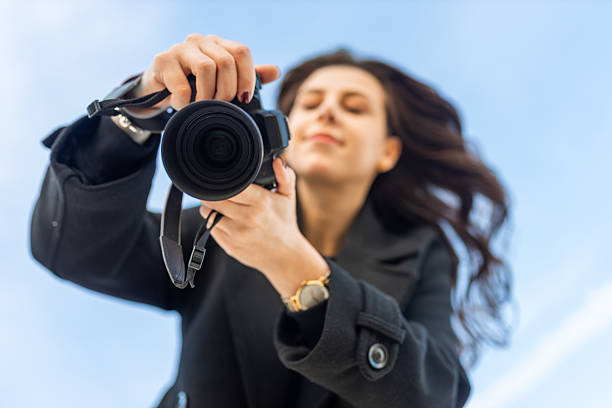 Woman taking photos in public park