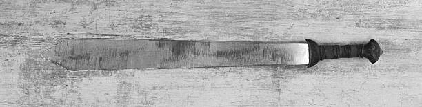 Spartan iron sword medieval weapon on wooden background