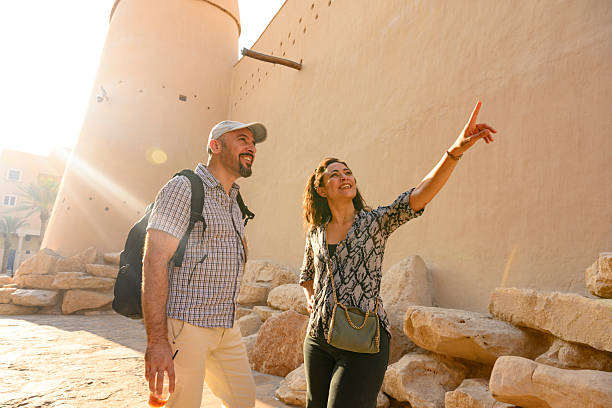 istock Tourist couple exploring ancient architecture with pointing woman 2254246388