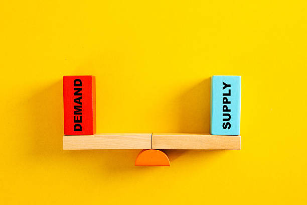 istock Demand and supply blocks balancing on a seesaw 2254248619