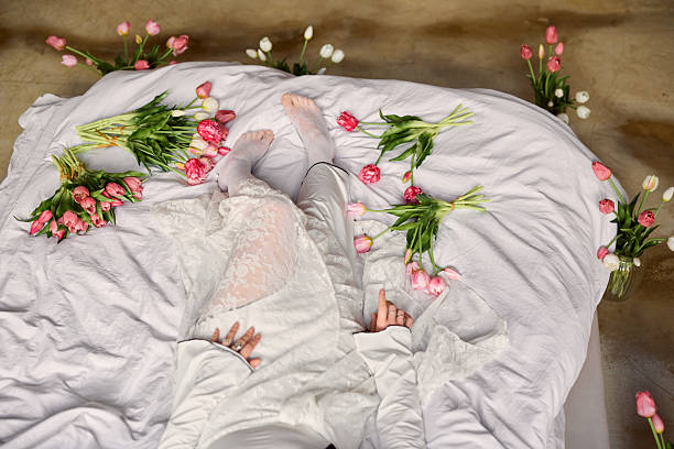istock Serene scene showcasing hands on blanket surrounded by tulips and soft pink blossoms for selfcare 2254249129