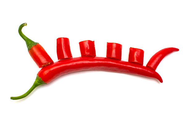 Red chili pepper cut into slices isolated on white background. Creative spicy sharp. Flat lay, top view