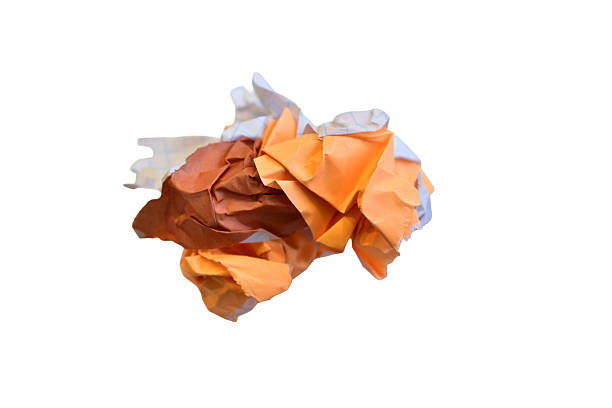 A lump of crumpled colored paper isolated on white background.
