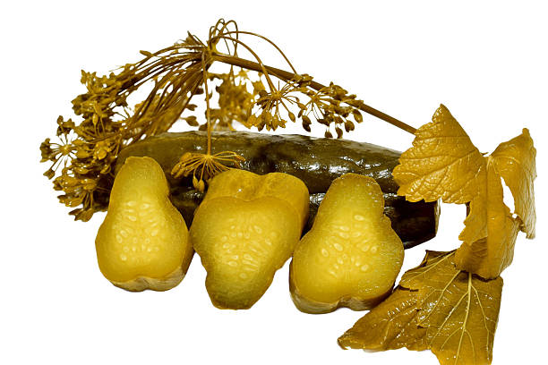 Pickled cucumber with a sprig of dill isolated on white background.