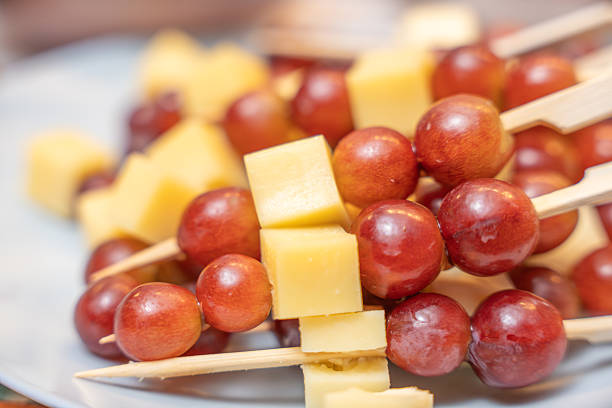 Cheese and Grape Skewers Close-Up. Close-up of cheese and grape skewers highlighting texture and color. Ideal finger food for elegant events and casual entertaining.
