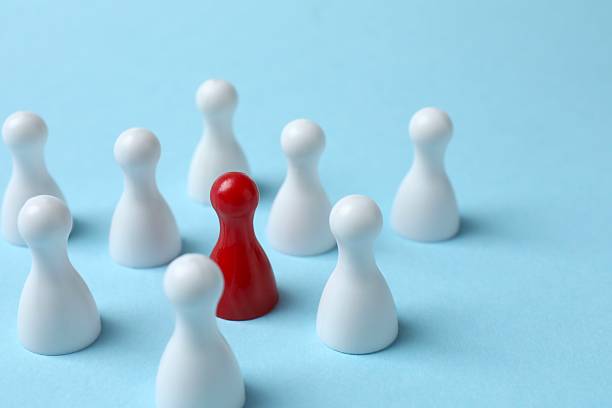 istock Group of colored pawns on the table. Concept of unity 2254252954