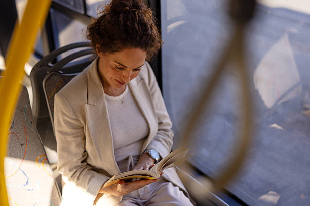 istock Public Transit Lifestyle – Woman Reading a Book 2254255788