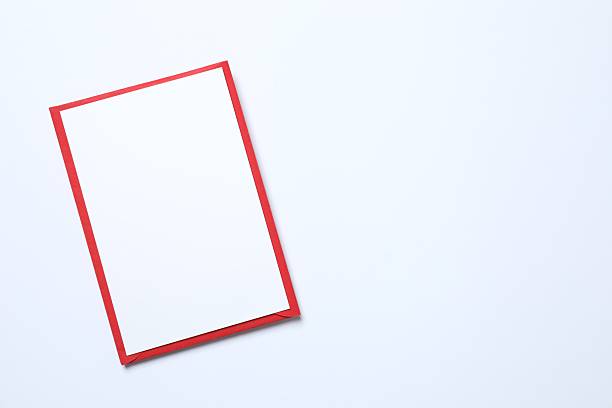 istock Red paper envelope and white card on white background with empty space 2254255850