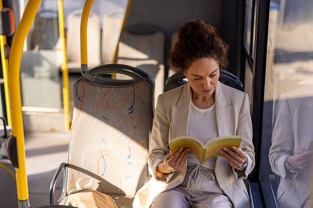 istock Woman Enjoying Personal Time Reading on Bus 2254255856