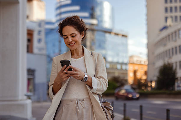 istock Woman Checking Smartphone in Urban Career Setting 2254255872