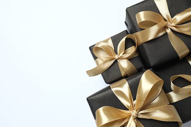 istock Beautiful festive gift boxes with golden bows on color background 2254256102