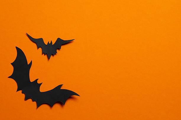 istock Halloween holiday card with black bats on orange background 2254256206