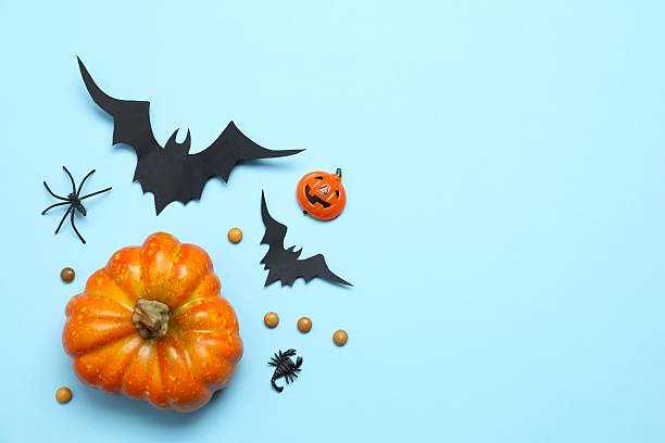 istock Halloween holiday decorations including pumpkins, spiders, bats on blue background 2254256289